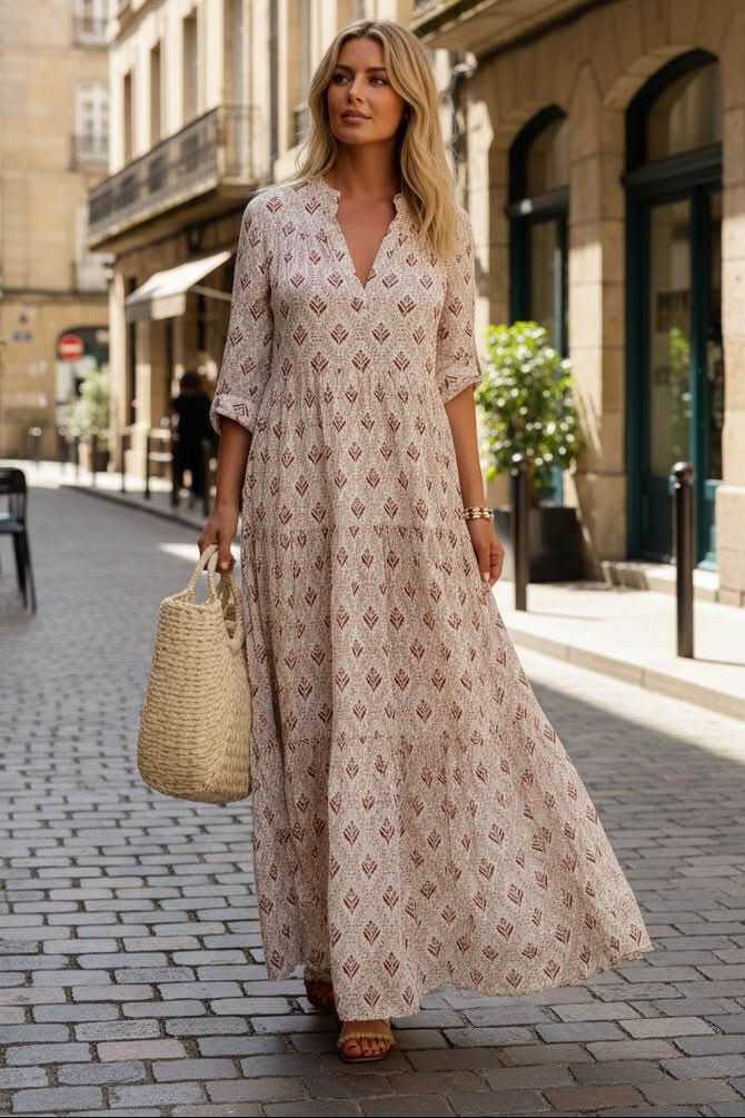 Elegant women's tiered maxi dress with a flowing design, ideal for vacation wear.