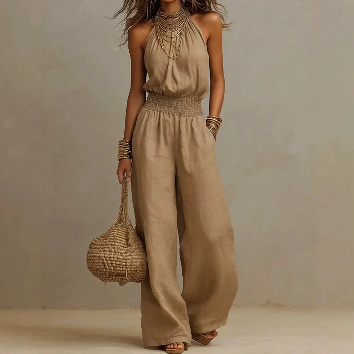 Women's flowing wide leg halter jumpsuit for summer casual or elegant vacation wear, comfortable & stylish.