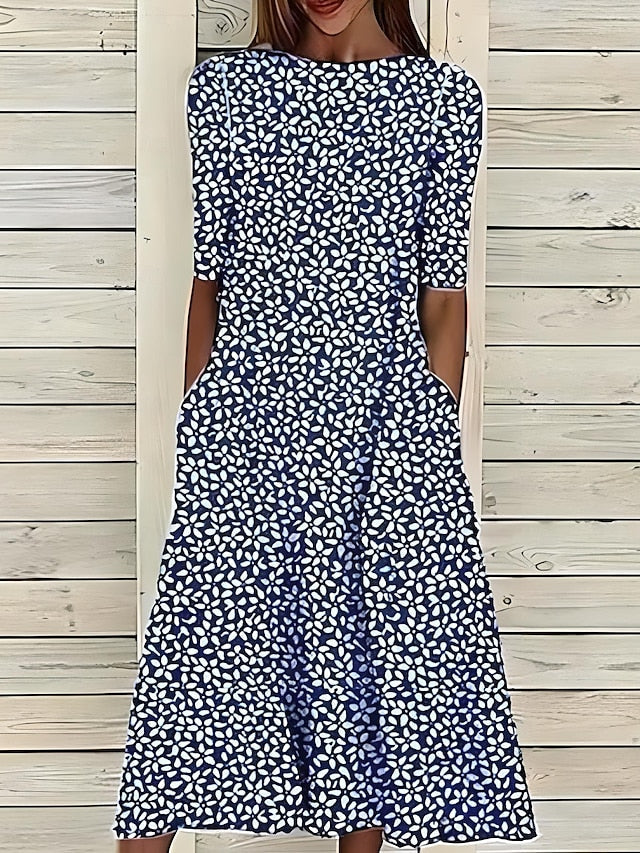 Chic women's flowy A-line midi dress featuring a stylish botanical print and essential pockets, great for versatile outfits.