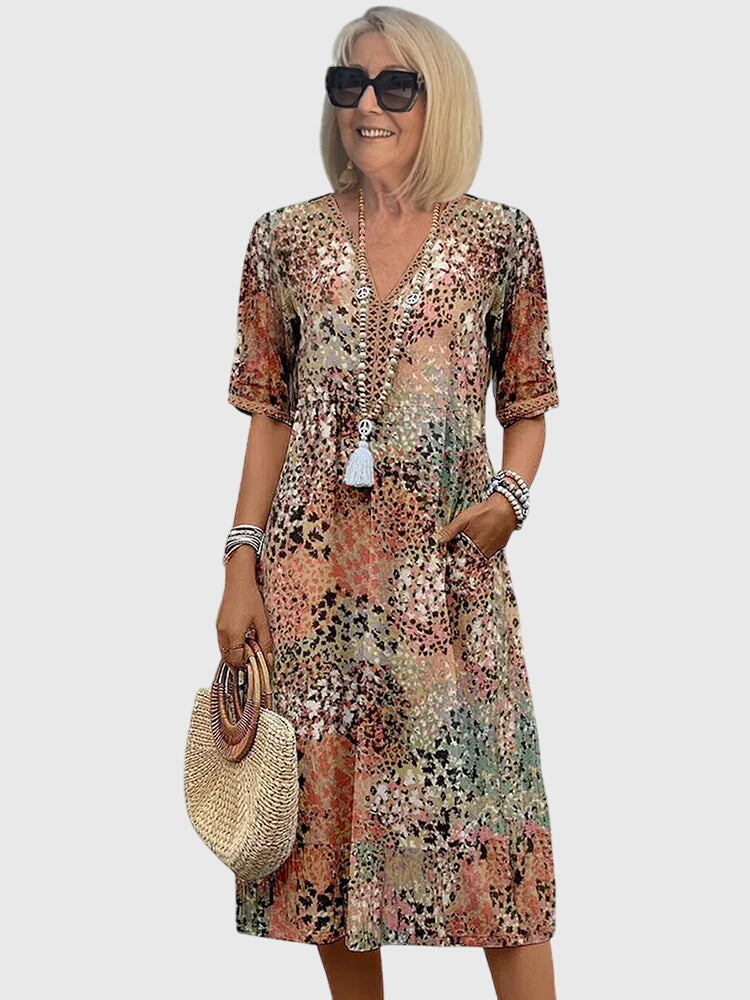 Women's flowy abstract print v-neck midi dress with flutter sleeves, perfect for summer casual wear or vacation.