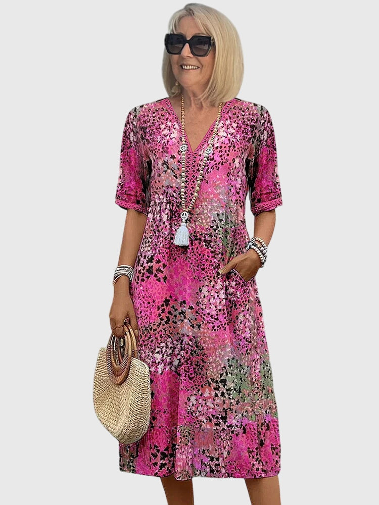 Elegant women's summer vacation dress, showcasing a unique abstract botanical print, flowy fit, and v-neck.