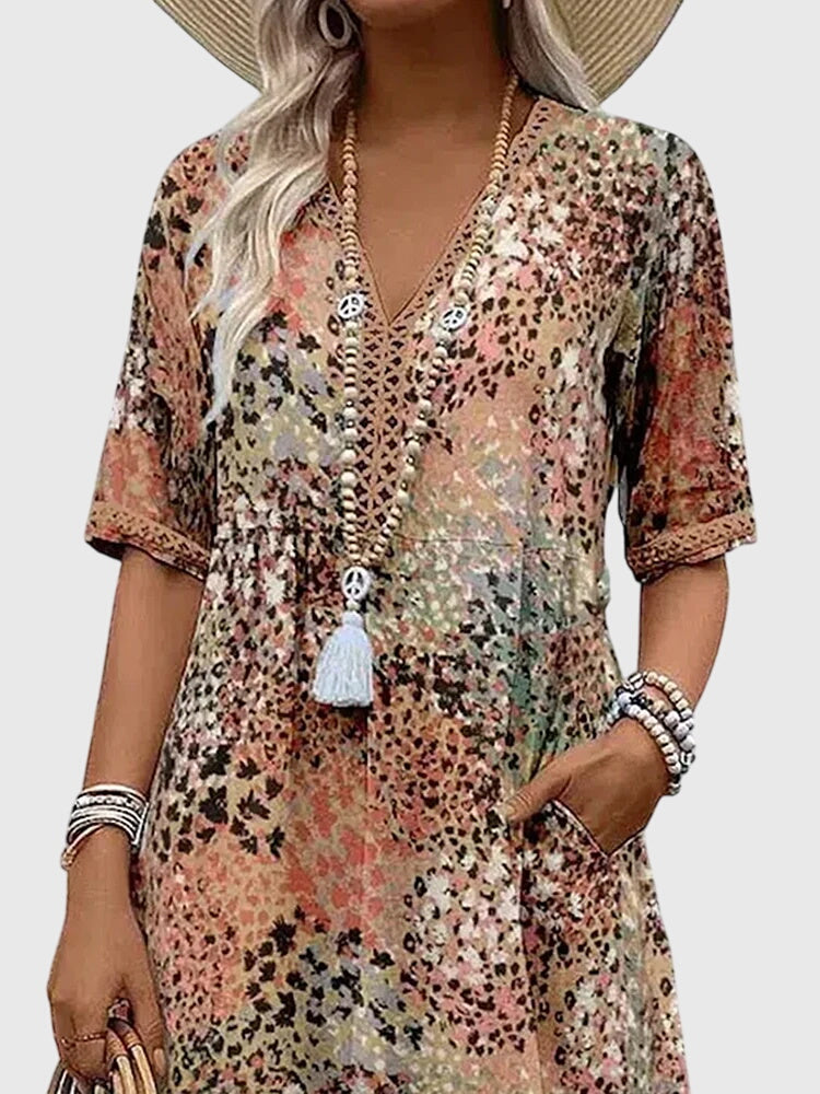 Lightweight flowy women's summer dress with abstract botanical print, v-neck, and flutter sleeves for comfort.