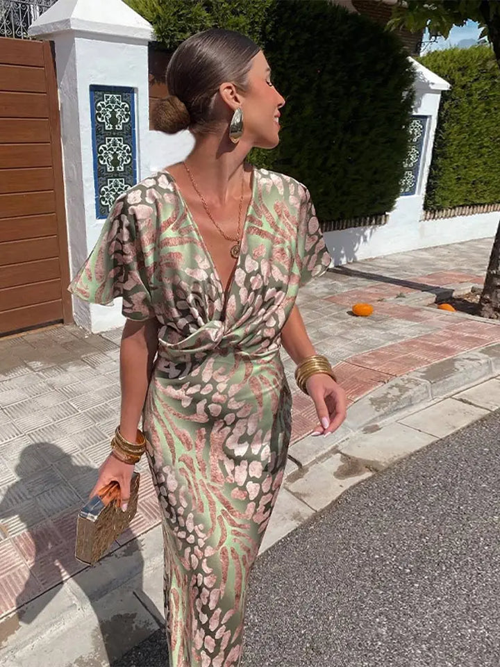 Women's flowy abstract print wrap midi dress, elegant and stylish for summer occasions & parties.