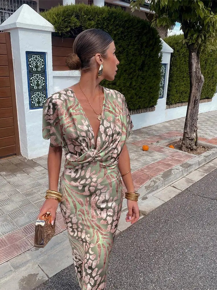 Stylish women's flowy abstract print wrap midi dress, versatile for casual wear or elegant party occasions.