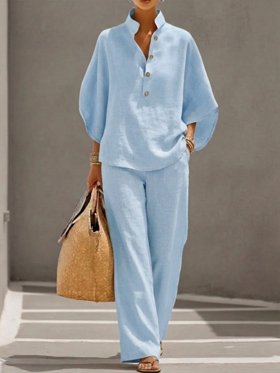 Elegant women's two-piece set featuring a batwing sleeve blouse and wide leg pants. Effortless fashion.