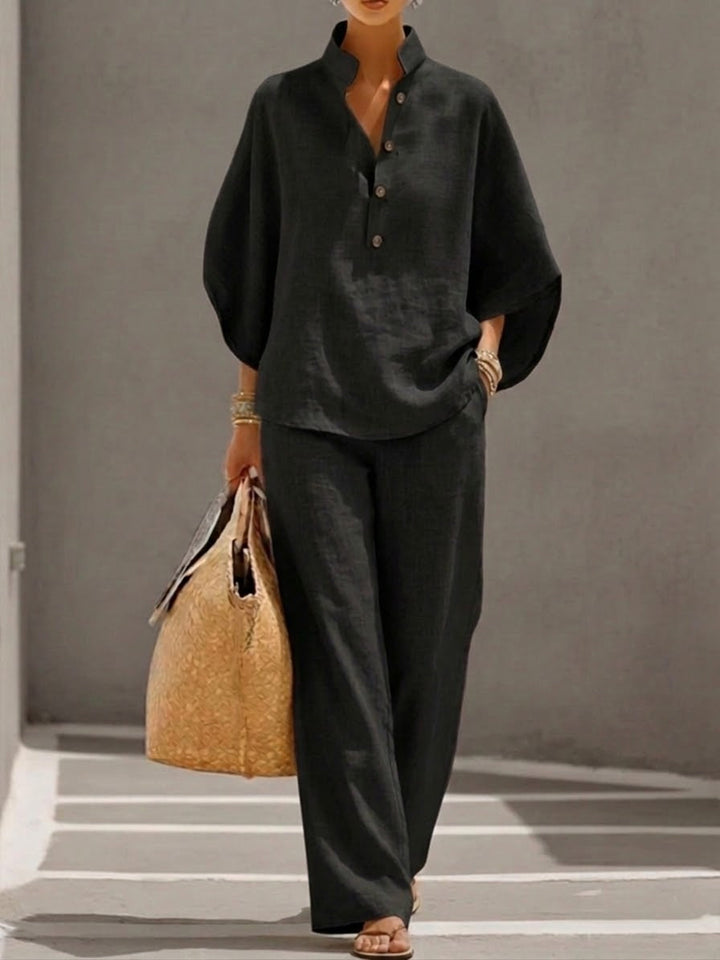 Women's batwing blouse and wide leg pants set, offering comfort and modern style. Versatile outfit.