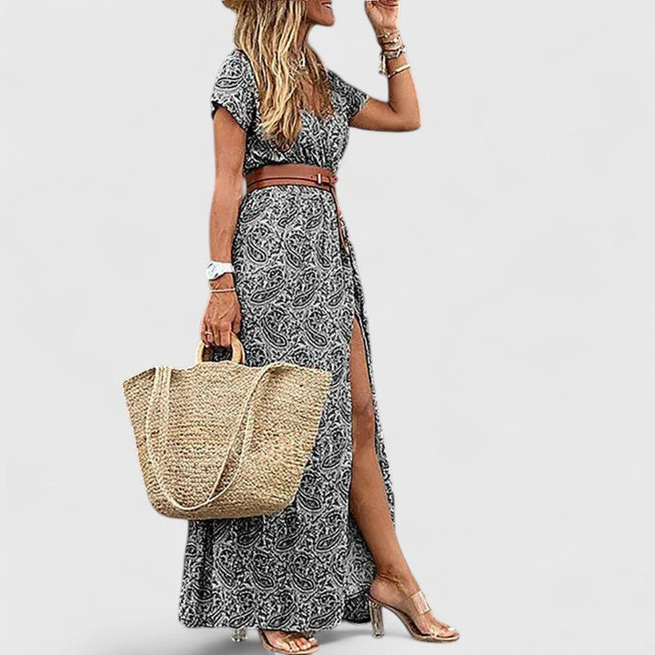 Full length view of a women's flowy boho maxi dress, showcasing its elegant silhouette. Perfect for summer vacations.