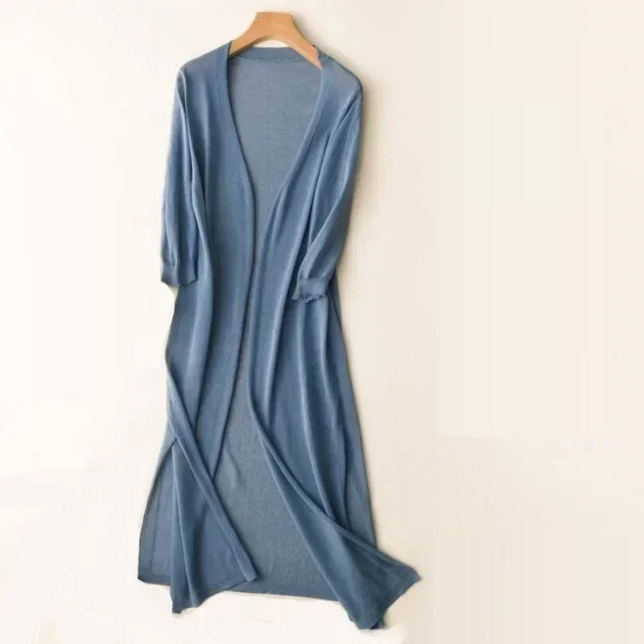 Soft women's long cardigan, open front & three-quarter sleeves. Features modern side slits for a flowy look.