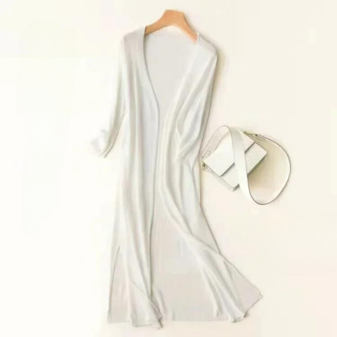 Women's elegant long cardigan in a flowy fabric, showcasing side slits. Perfect outerwear for warmer weather.