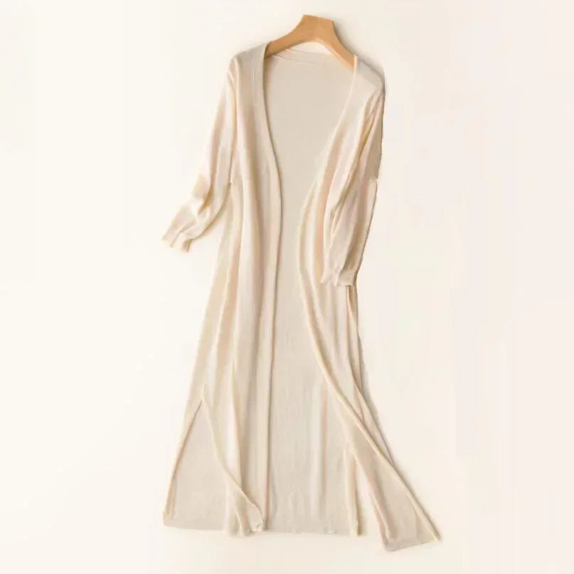 Open-front women's long cardigan with three-quarter sleeves. Features fashionable side slits for a relaxed fit.