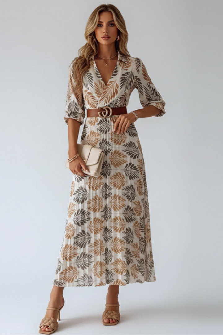 Elegant women's patterned maxi dress with elbow sleeves. Flowy design for spring/summer fashion.