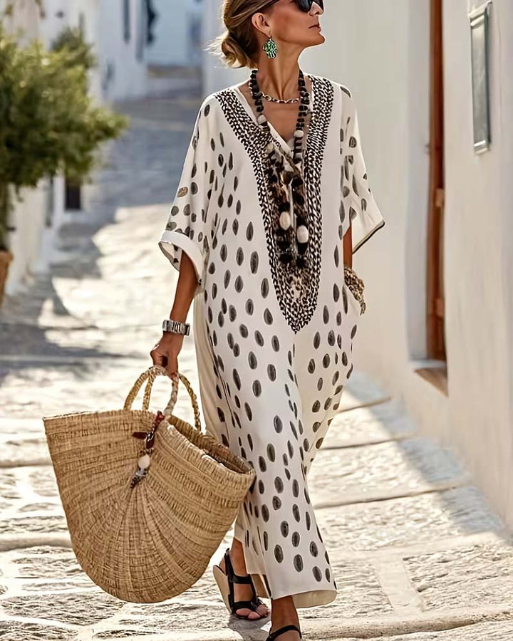 Women's flowy polka dot maxi kaftan dress with intricate embroidery, perfect for summer vacations.