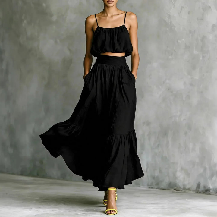 Flowy women's two-piece set featuring a ruffle hem maxi skirt and spaghetti strap crop top.