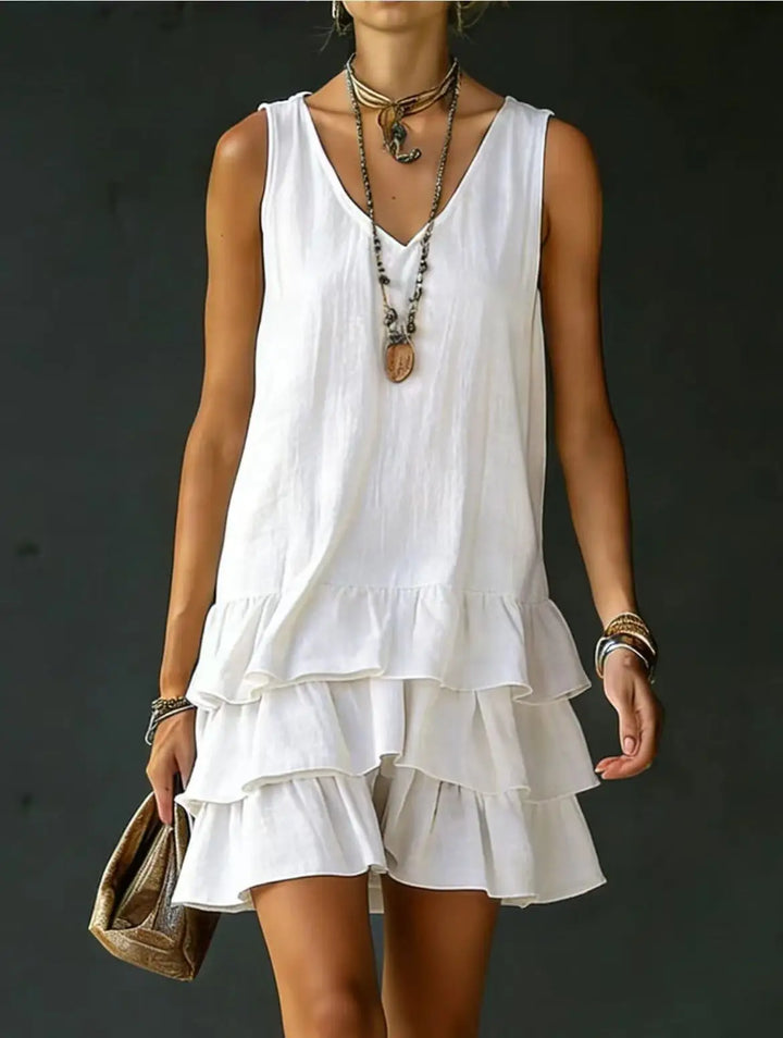 Chic women's multi-color tiered mini dress with playful ruffles. V-neck, sleeveless, ideal for summer casual style.