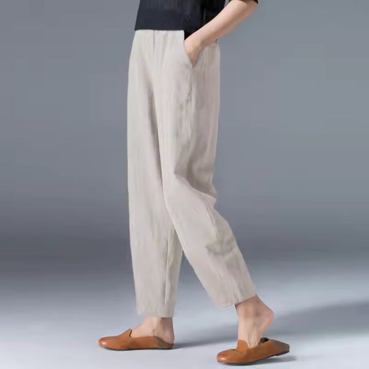 Woman wearing versatile flowy summer trousers with elastic waist. Comfortable travel pants, perfect for light, breathable style.