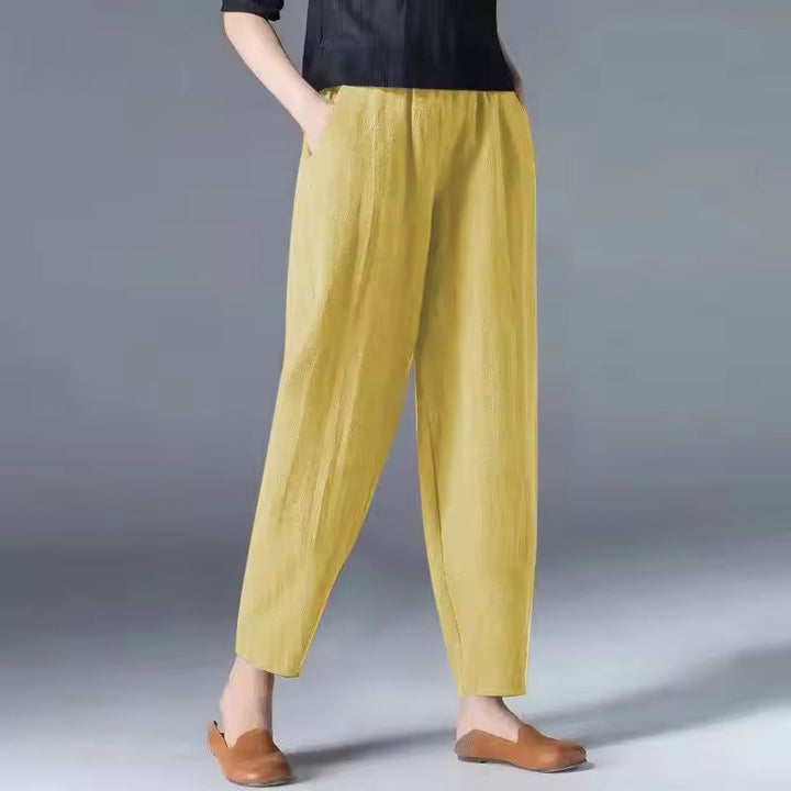 Elastic waist detail on women's flowy summer trousers, ensuring a comfortable, relaxed fit. Breathable summer pants.
