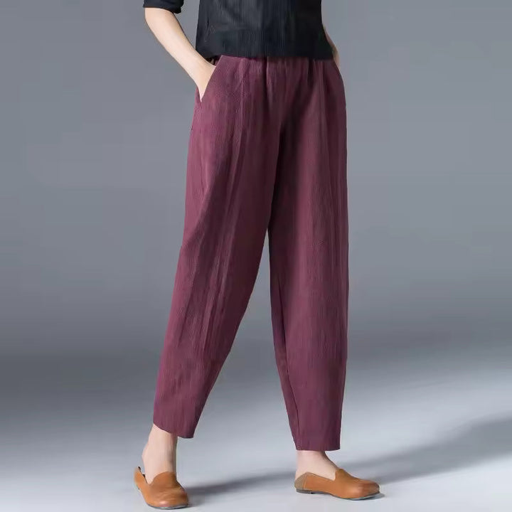Woman demonstrating the flowy movement of comfortable summer trousers. Relaxed fit, breathable travel pants.