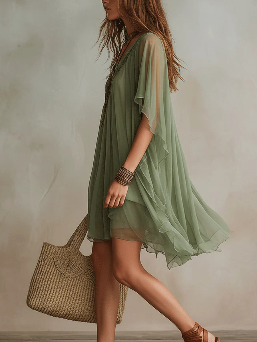 Relaxed fit women's flowy V-neck mini dress with layered skirt, ideal for comfortable spring and summer wear.