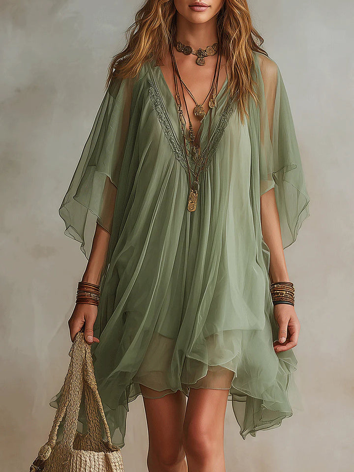 Stylish women's layered mini dress featuring a flattering V-neck and flowy silhouette, great for spring/summer fashion.