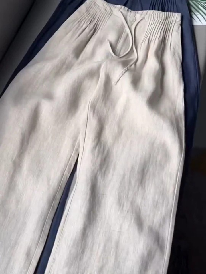 Modern women's wide-leg pants with a flowy silhouette & elastic waist, perfect for chic casual looks.