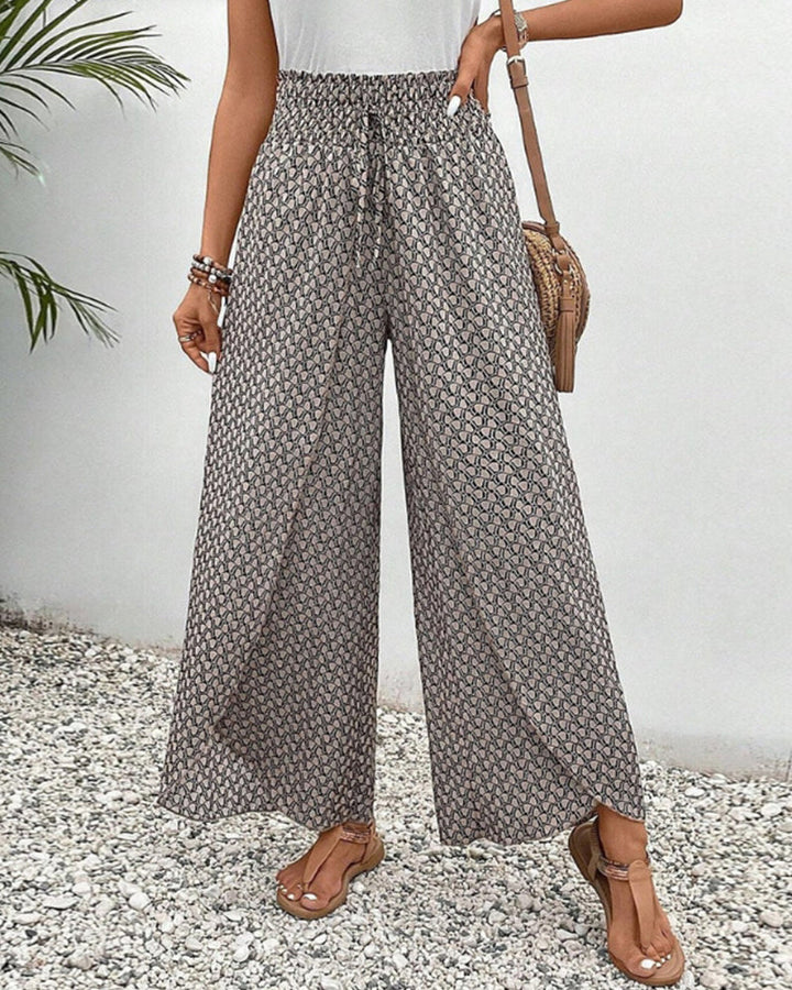 Women's geometric print wide-leg trousers, relaxed fit. Stylish casual patterned pants for versatile fashion.