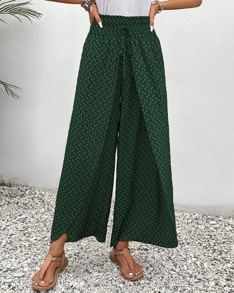 Detail of comfortable waistband on women's relaxed fit wide-leg trousers. Stylish geometric patterned pants.