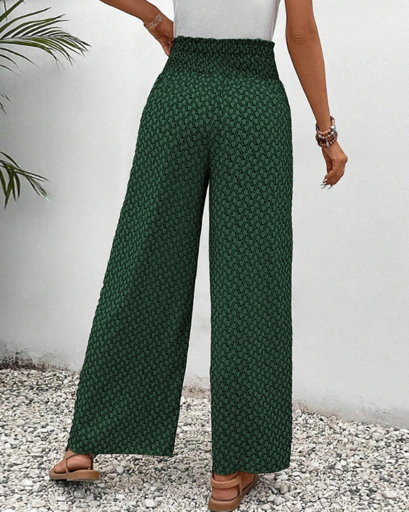Women's wide-leg trousers with geometric print, relaxed fit. Shows flow & movement for elegant casual wear.