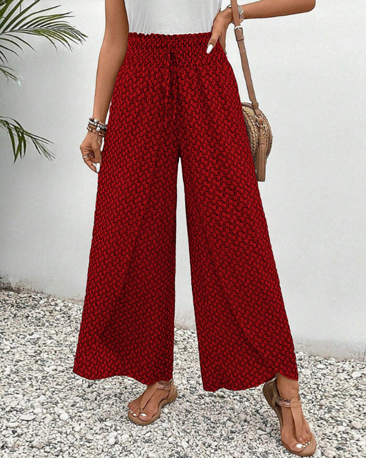 Flowy women's wide-leg trousers in a comfortable relaxed fit. Showcases vibrant geometric pattern for style.