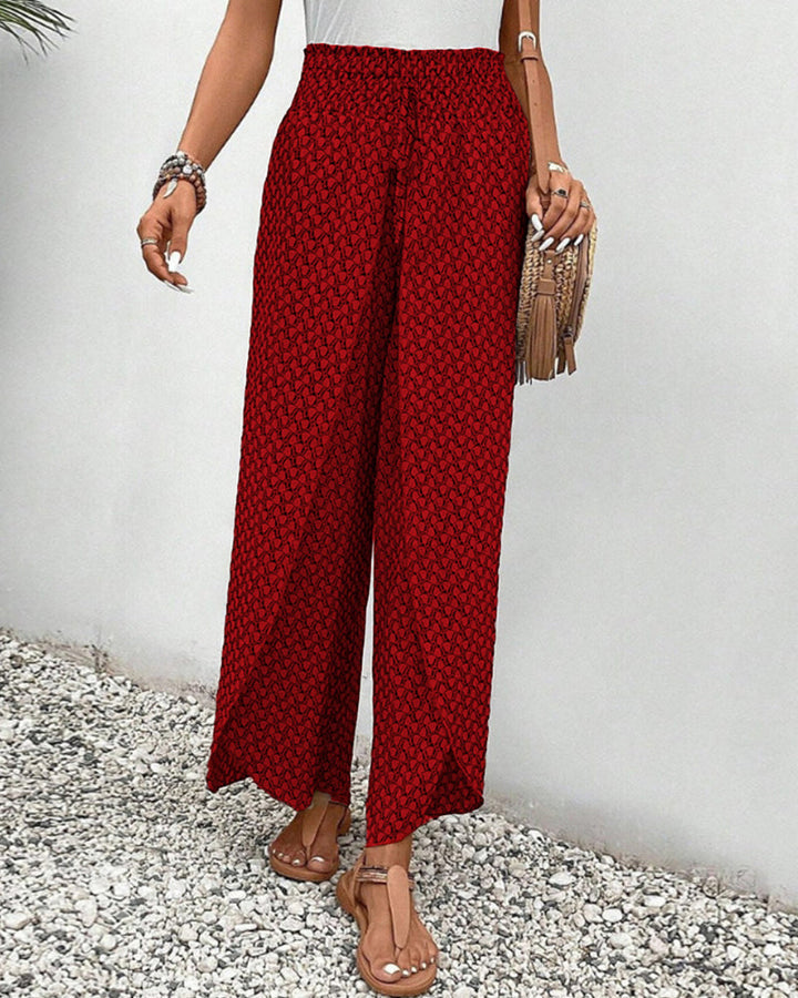 Back view of women's geometric print wide-leg trousers. Highlights relaxed fit & stylish patterned design.