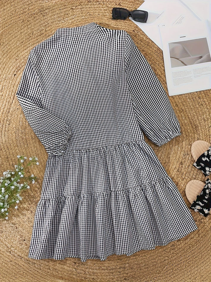 Versatile women's gingham mini dress with puff sleeves, button-front, and tiered hem, great for spring outfits.