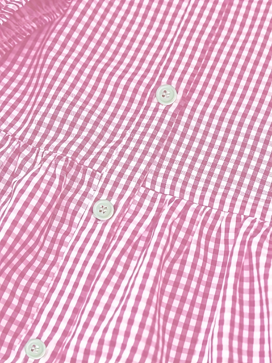 Detail shot of women's gingham check mini dress showing button front, tiered ruffles, and puff sleeve.