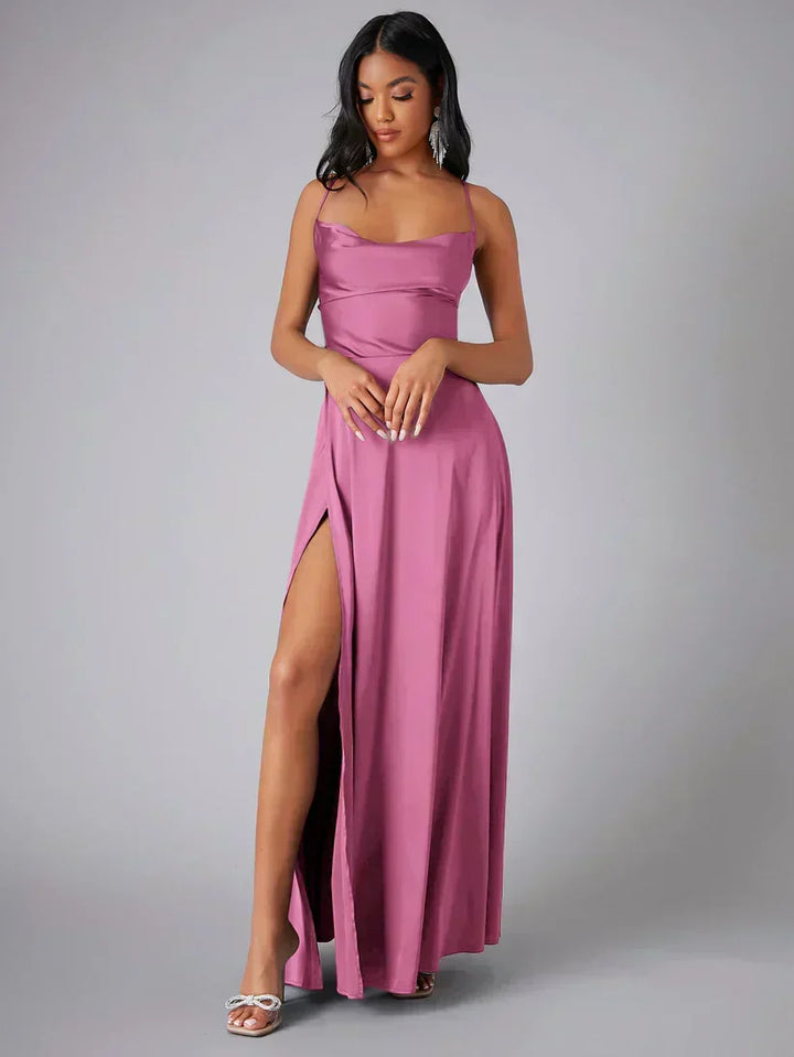 Black women's glamorous maxi evening gown with a dramatic high slit and open back for parties.