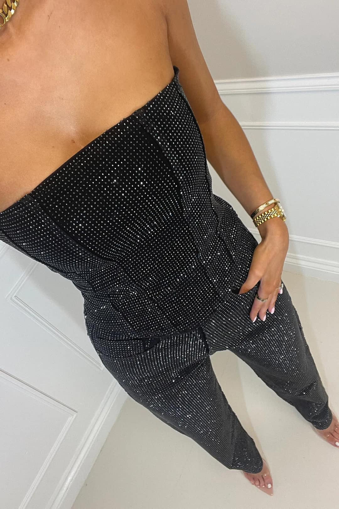 Women's two-piece party set: dazzling glitter top paired with trendy high-waisted jeans ensemble.