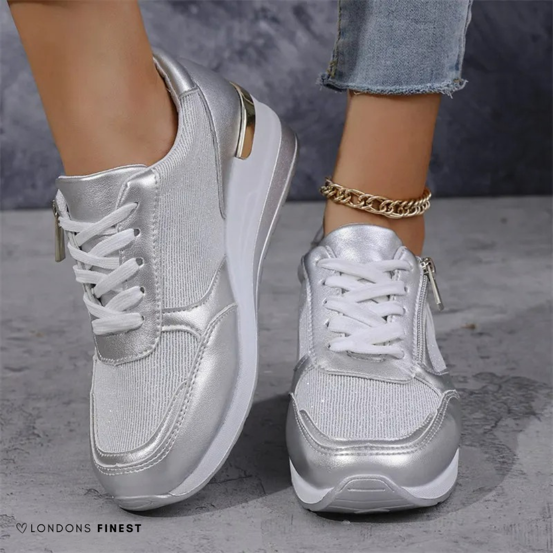 Lightweight women's silver sneakers with arch support and cushioned comfort for active lifestyles.