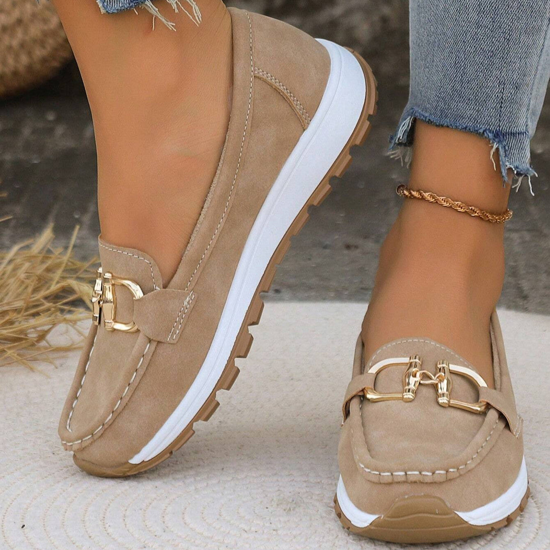 Women's gold buckle comfort loafers. Slip-on everyday footwear for versatile style.