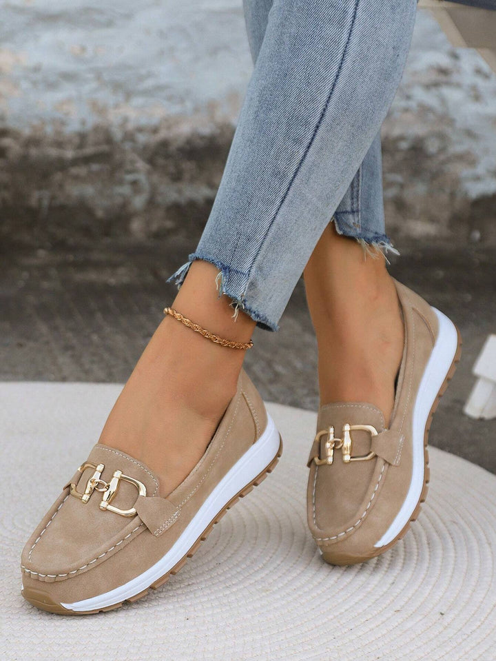 Stylish women's gold buckle loafers. Comfortable slip-on shoes for everyday wear and office.