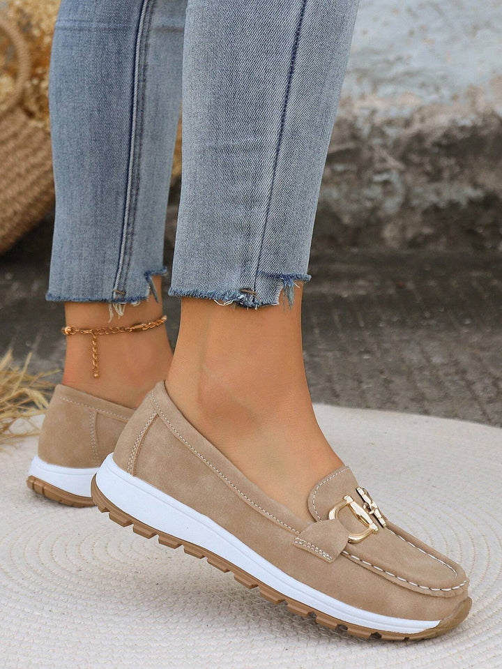 Classic women's gold buckle loafers. Elegant everyday footwear, ideal for office and casual style.
