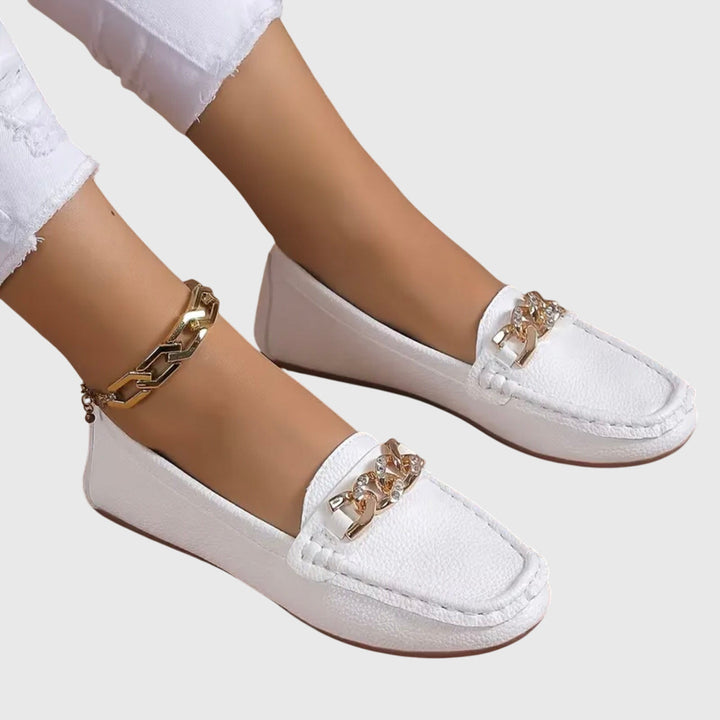 Women's comfortable wedge loafers with a sleek gold chain, a stylish and versatile slip-on shoe.