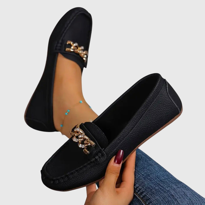 Slip-on wedge loafers for women, featuring a prominent gold chain and cushioned footbed.