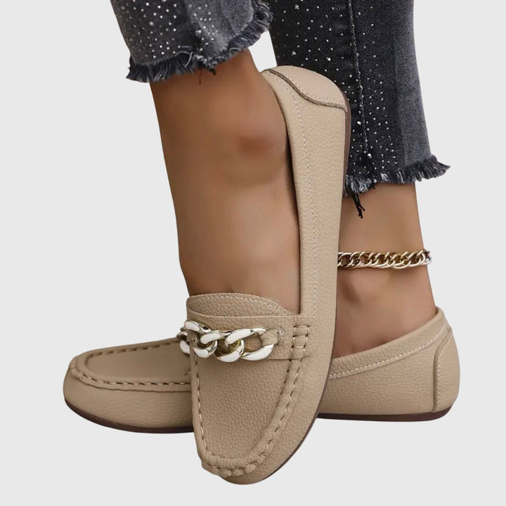 Stylish women's gold-chain wedge loafers, easy slip-on comfort for everyday elegance.