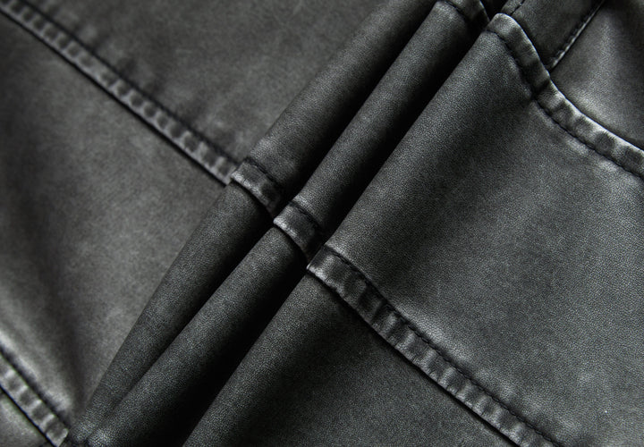 Detail of the collar and zipper on a women's gray moto-style faux leather jacket, showcasing quality.