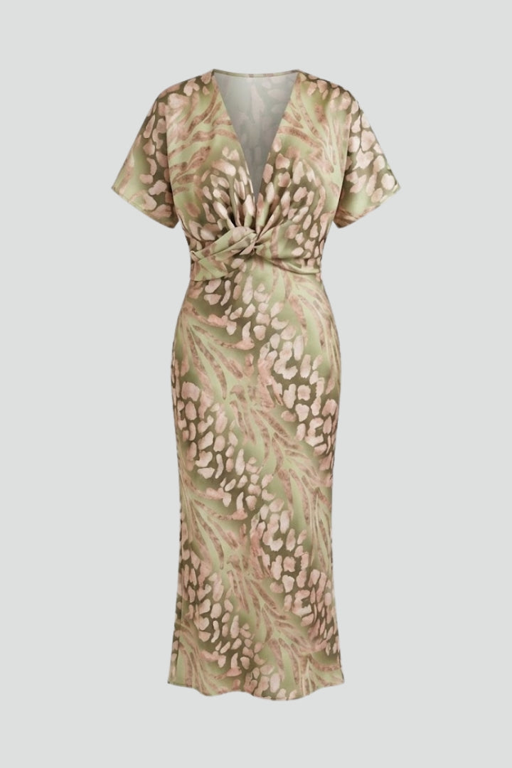 Women's green floral midi dress with V-neck, short sleeves, and elegant pleated hem for summer garden parties.
