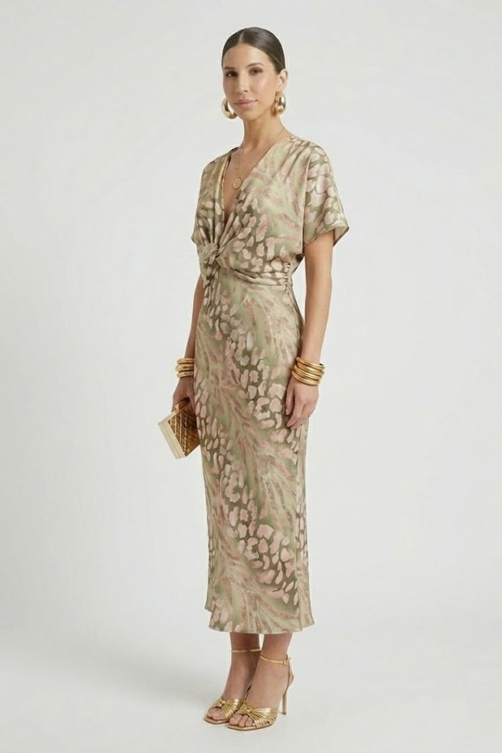 Women's casual green floral midi dress with a flattering V-neck, short sleeves, and flowy pleated hem detail.