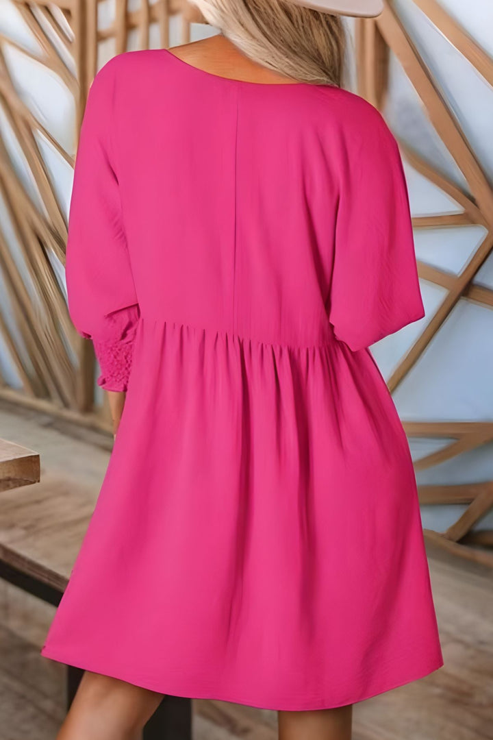 Comfortable half sleeve smocked babydoll mini dress for women with a flattering tiered ruffle design.