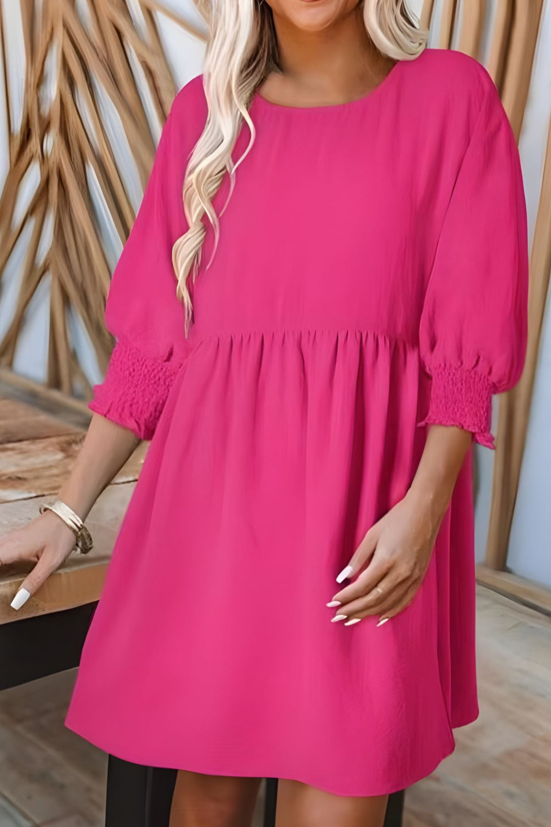 Smocked babydoll mini dress with a comfortable, flattering fit and playful ruffle details.