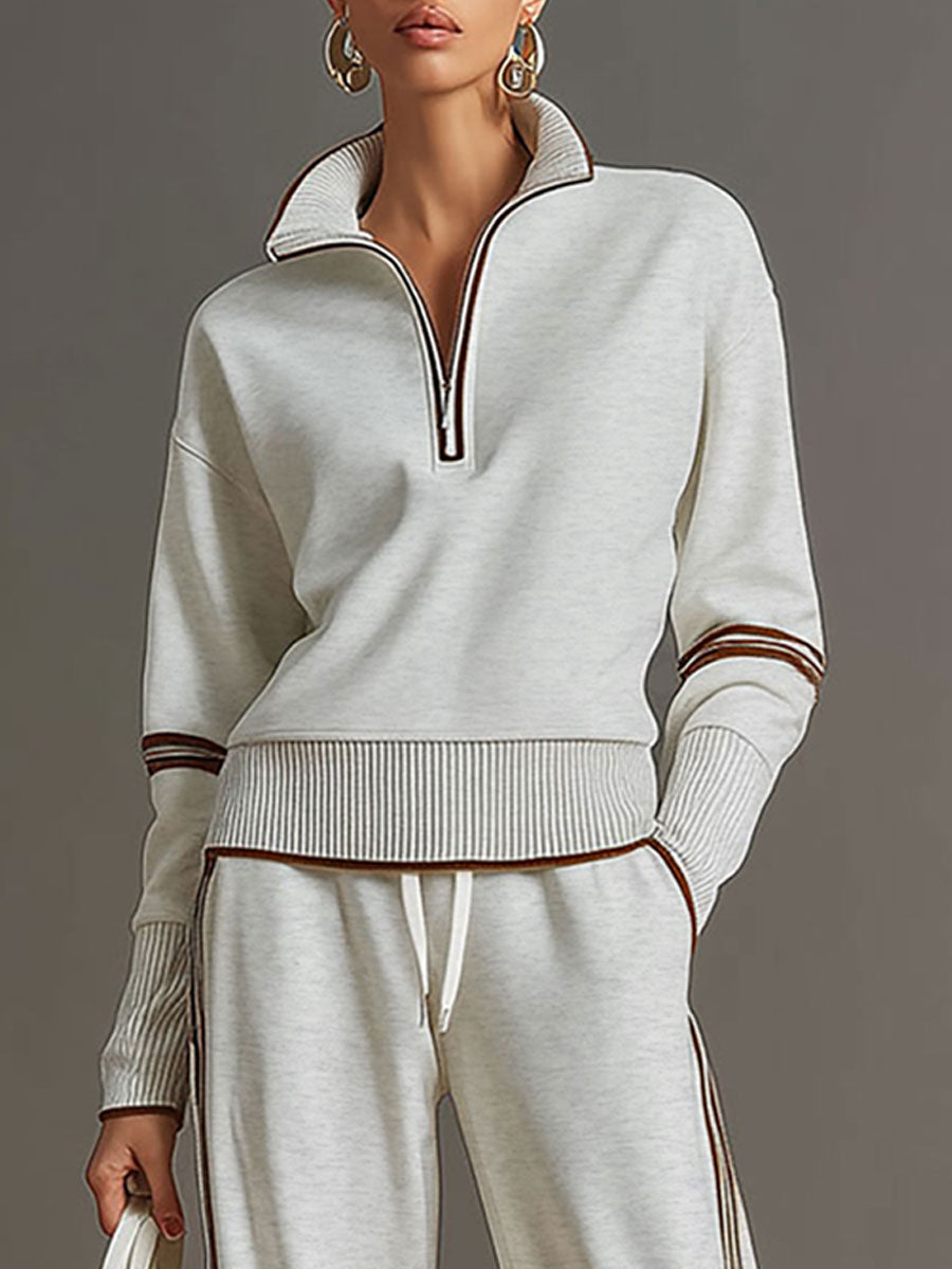 Elegant women's casual set: half-zip sweatshirt paired with wide-leg trousers for a sophisticated lounge look.