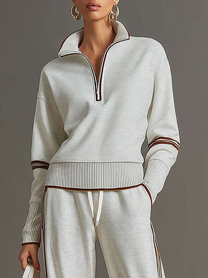 Elegant women's casual set: half-zip sweatshirt paired with wide-leg trousers for a sophisticated lounge look.