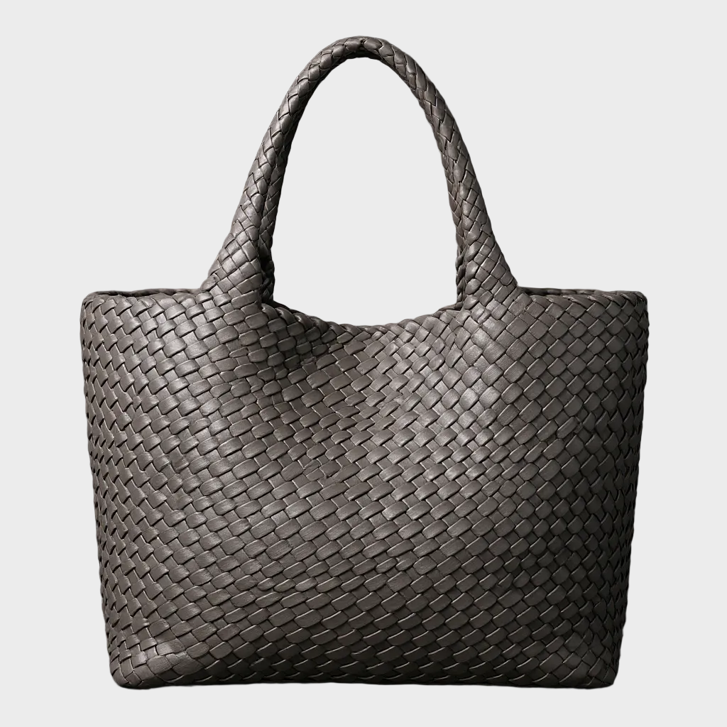 Close-up of a women's handwoven leather tote bag texture. Large, stylish shoulder bag, perfect for everyday fashion.