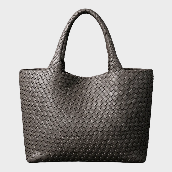Close-up of a women's handwoven leather tote bag texture. Large, stylish shoulder bag, perfect for everyday fashion.