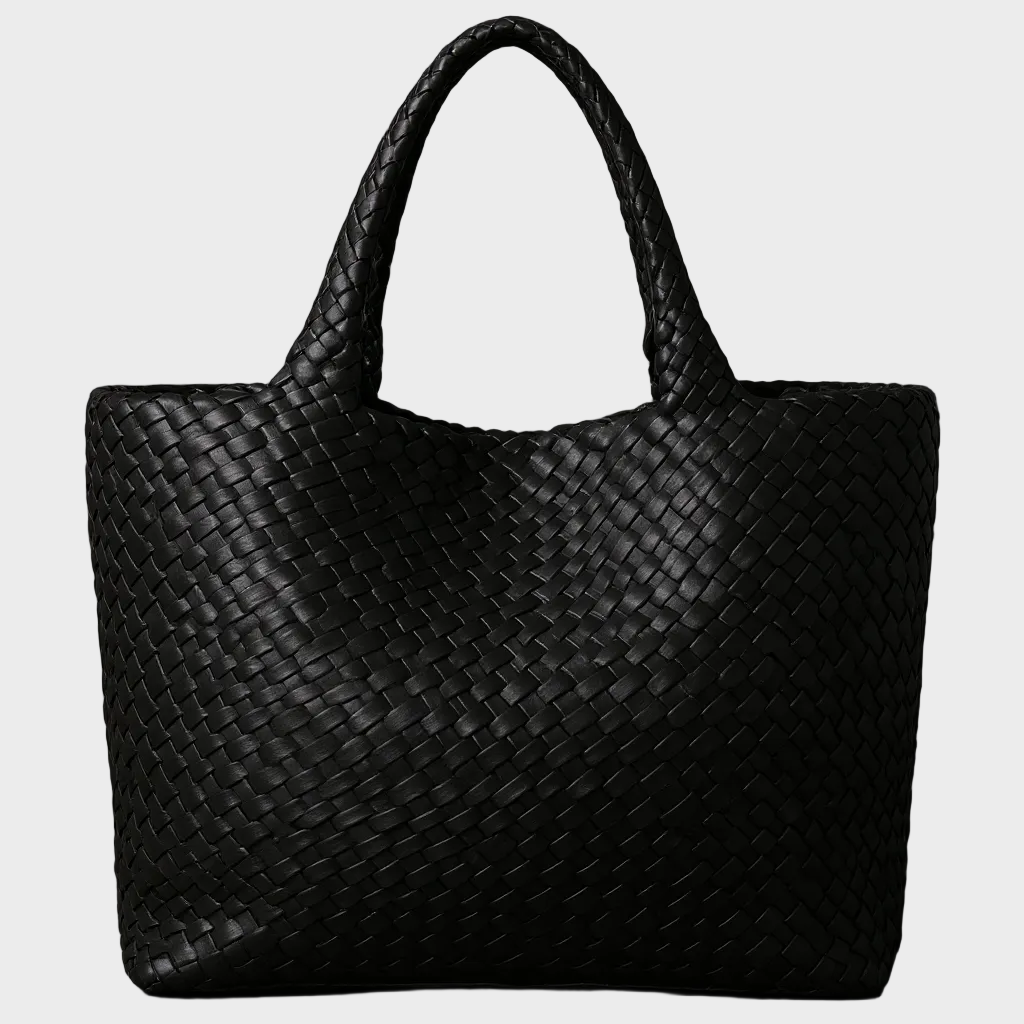 Women's handwoven leather large tote bag carried by a woman. Stylish everyday shoulder bag for work or leisure.
